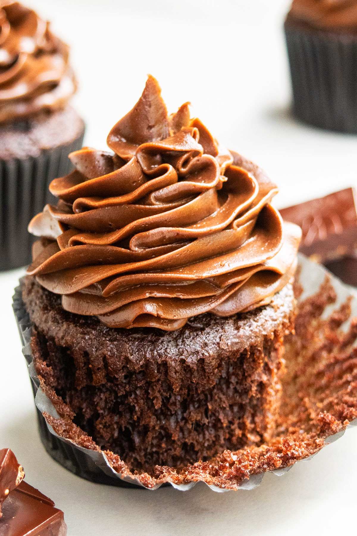 Best Easy Chocolate Cupcakes with Chocolate Buttercream Frosting- Liner Partially Peeled. 
