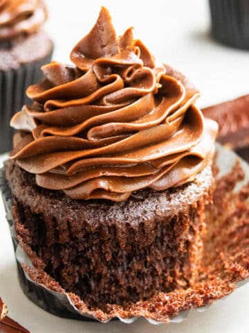 Best Easy Soft and Moist Chocolate Cupcakes With Chocolate Buttercream Frosting- Liner Partially Removed.