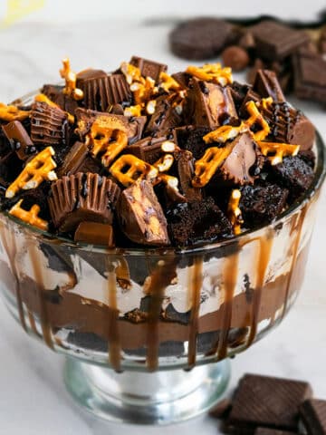 Easy Chocolate Trifle in Large Glass Bowl on White Marble Background.
