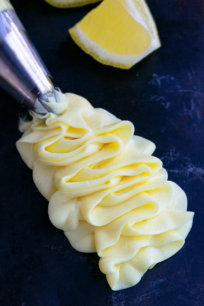 Lemon Cream Cheese Frosting Piped on Rustic Black Background