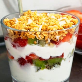 Homemade Yogurt Parfait in Glass Cup With Fresh Fruits and Granola Layers.