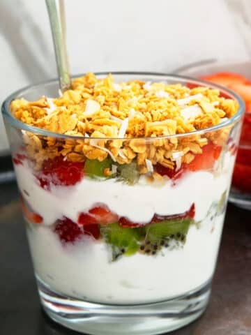 Homemade Yogurt Parfait in Glass Cup With Fresh Fruits and Granola Layers.