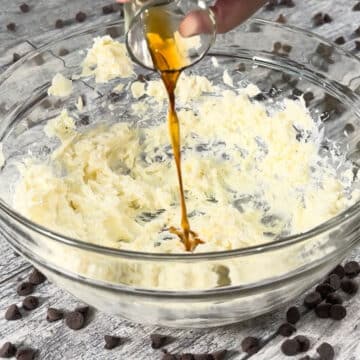 Vanilla extract being added to mixture in bowl. 