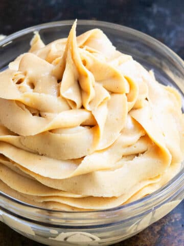 Glass bowl of easy homemade peanut butter frosting with 4 ingredients.