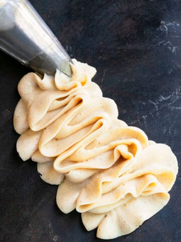Easy Maple Frosting Piped on Black Background
