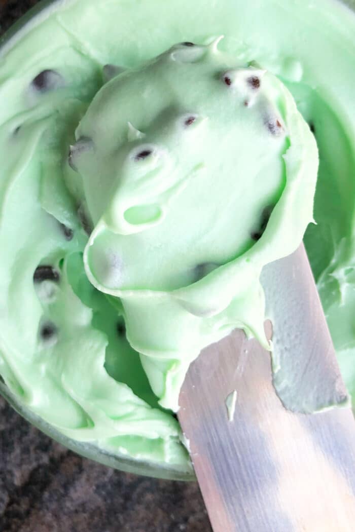 Closeup shot of spatula full of icing. 