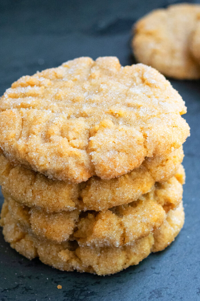 Stack of Best Easy Classic Peanut Butter Cookies on charcoal background.
