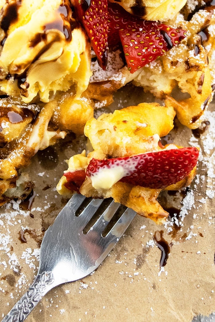 Closeup of Homemade Funnel Cake Bite and Strawberry on a Fork