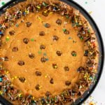 Easy Chocolate Chip Cookie Cake with Chocolate Frosting Served on a Black Plate