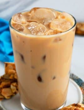 Iced Vanilla Latte in a Clear Glass on a Plate with Cookies