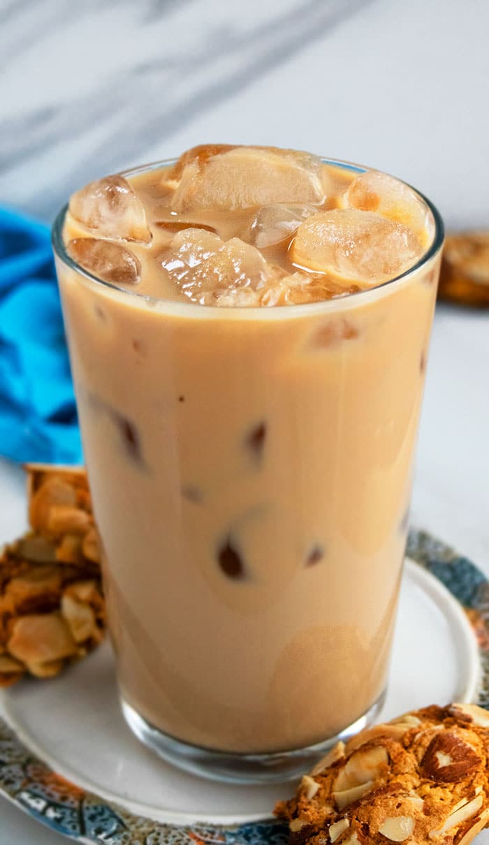 Iced Vanilla Latte in a Clear Glass on a Plate with Cookies