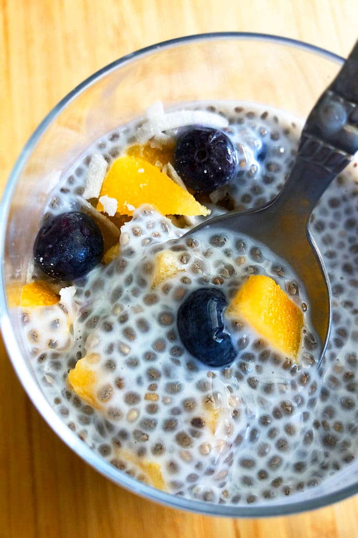 Spoonful of Easy Vanilla Chia Seed Pudding With Fresh Fruits in a Clear Cup