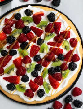 Easy Sugar Cookie Fruit Pizza on Black Plate