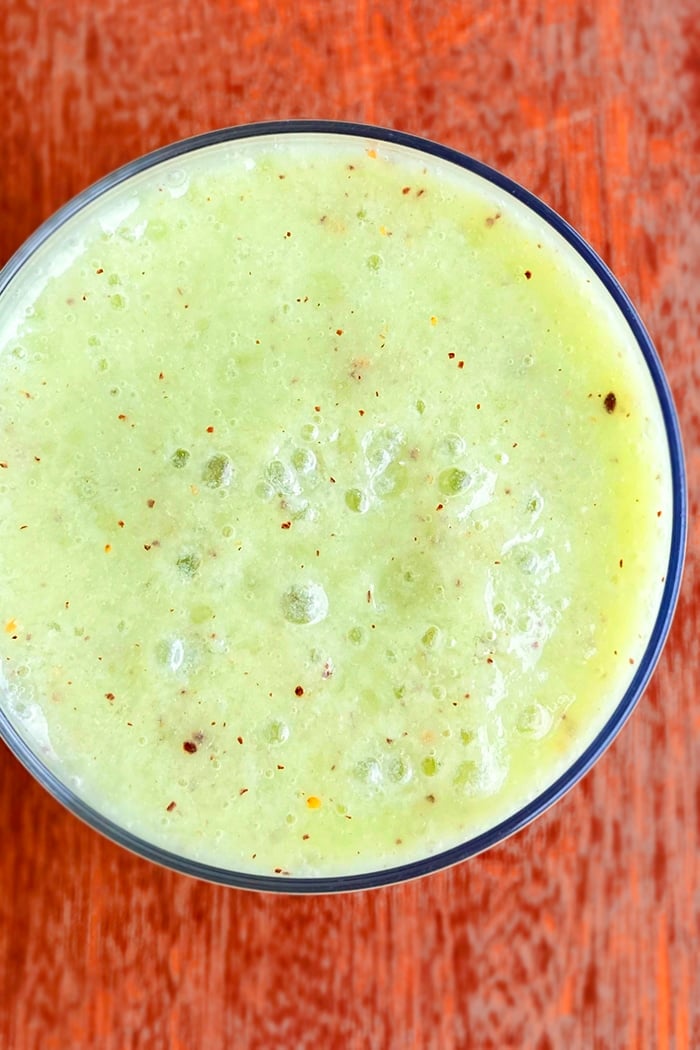 Overhead Closeup Shot of Easy Kiwi Banana Smoothie in Clear Cup