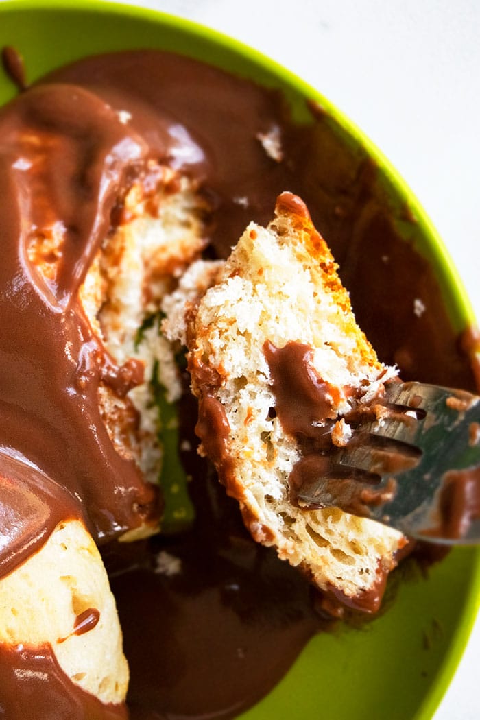 Fork With Bite of Biscuit Covered in Chocolate Gravy on Green Plate