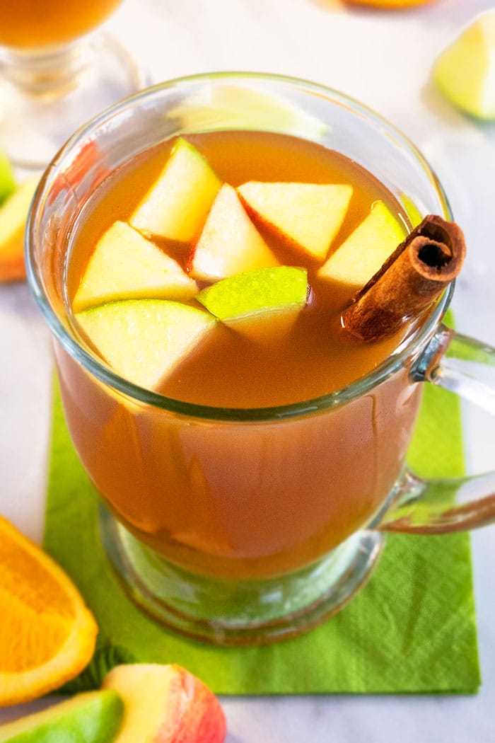 Overhead Shot of Homemade Apple Cider in Clear Cup on White Background