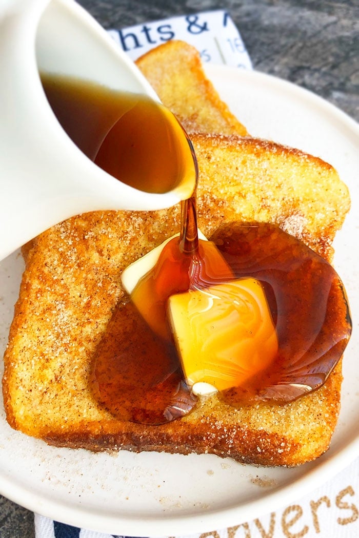 Syrup Being Poured on Fluffy French Toast on White Plate
