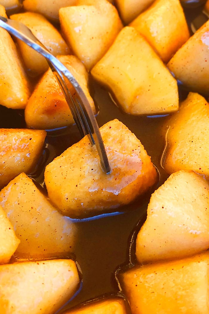 Diced Sauteed Apples on a Fork in Cinnamon Sugar Sauce