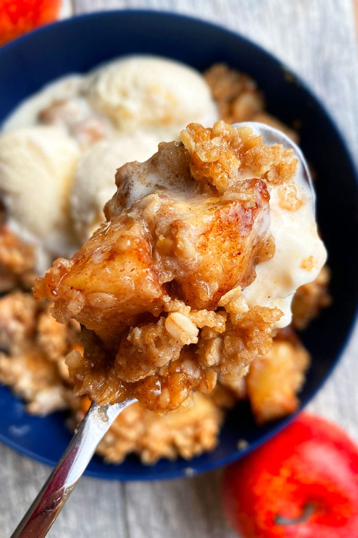 Spoonful of Homemade Apple Cobbler in Blue Bowl