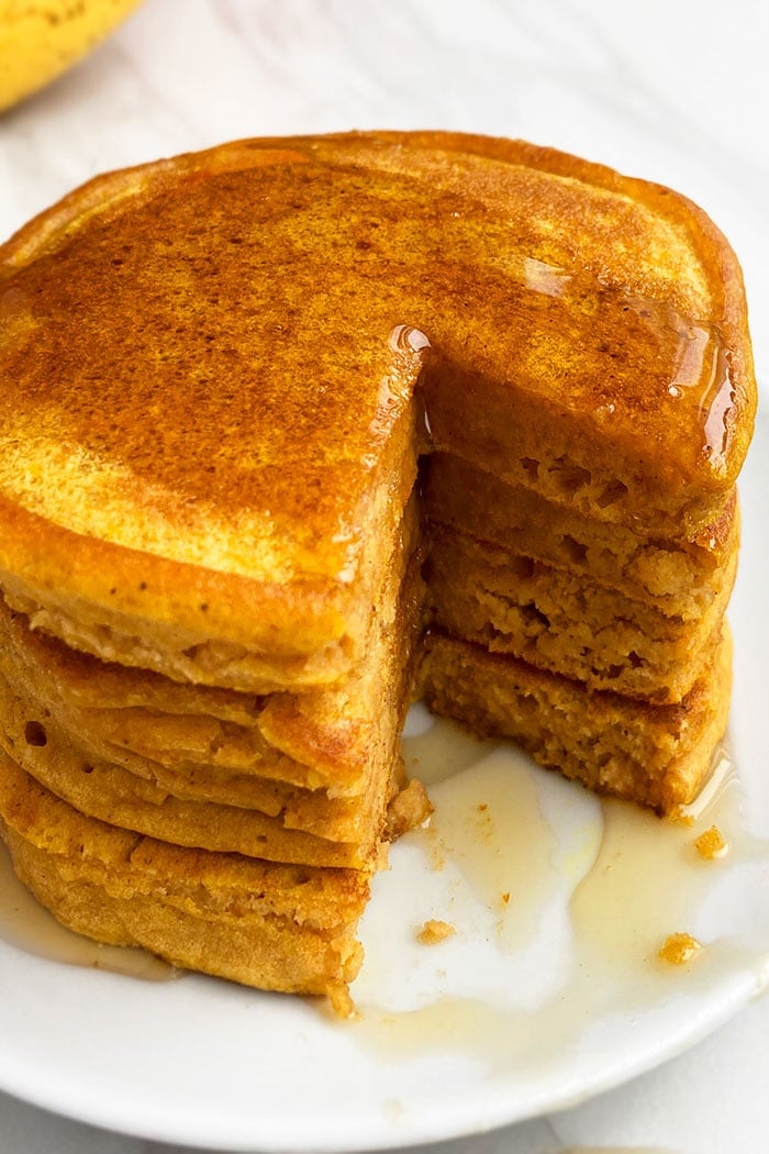 Stack of Homemade Pancakes with Slices Cut Out