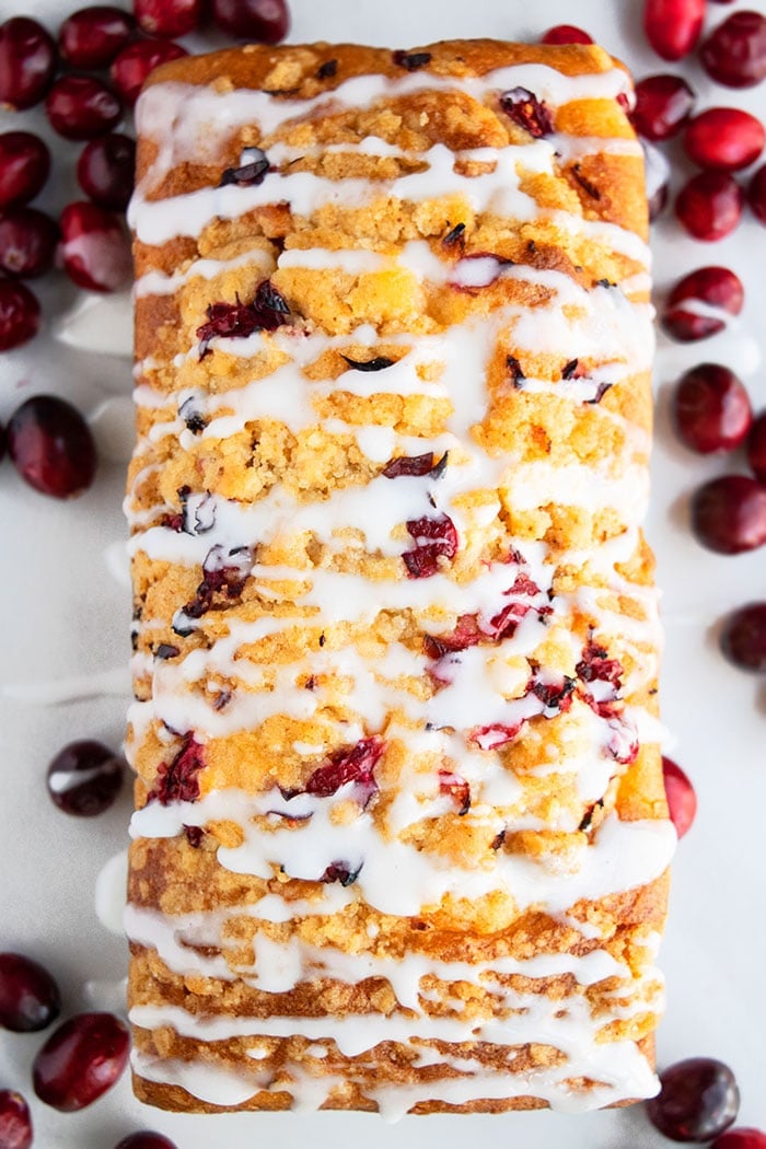 Easy Cranberry Loaf with Orange Glaze on White Surface- Overhead Shot