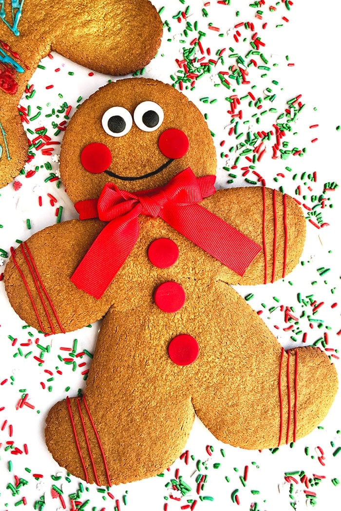 Jumbo Gingerbread Men Cookies on White Background With Sprinkles Scattered Everywhere