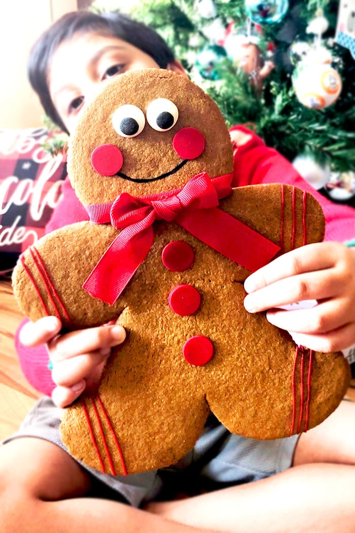 Kid Holding Jumbo Gingerbread Man Cookie