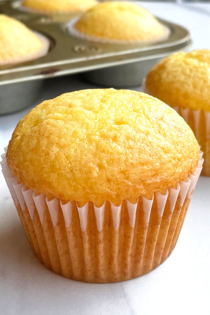 Unfrosted Yellow Cupcake on White Background