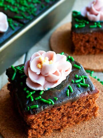 Chocolate Cake Decorated with Pink Royal Icing Flowers and Green Sprinkles