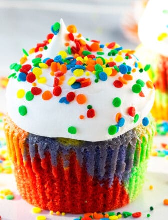 Easy Rainbow Cupcakes With Cake Mix Decorated with Whipped Cream and Colorful Sprinkles