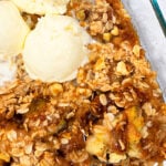 Easy Homemade Banana Crumble in Glass Dish with Scoops of Vanilla Ice Cream