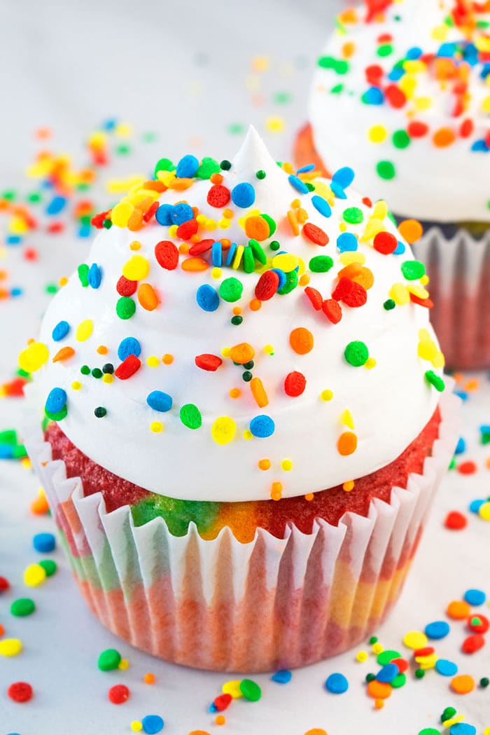 Tie Dye Cupcakes with White Icing and Colorful Sprinkles on White Background