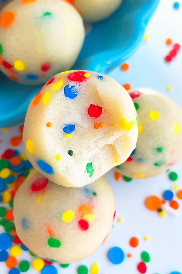 Homemade No Bake Rainbow Cookie Dough Bites on White Background 
