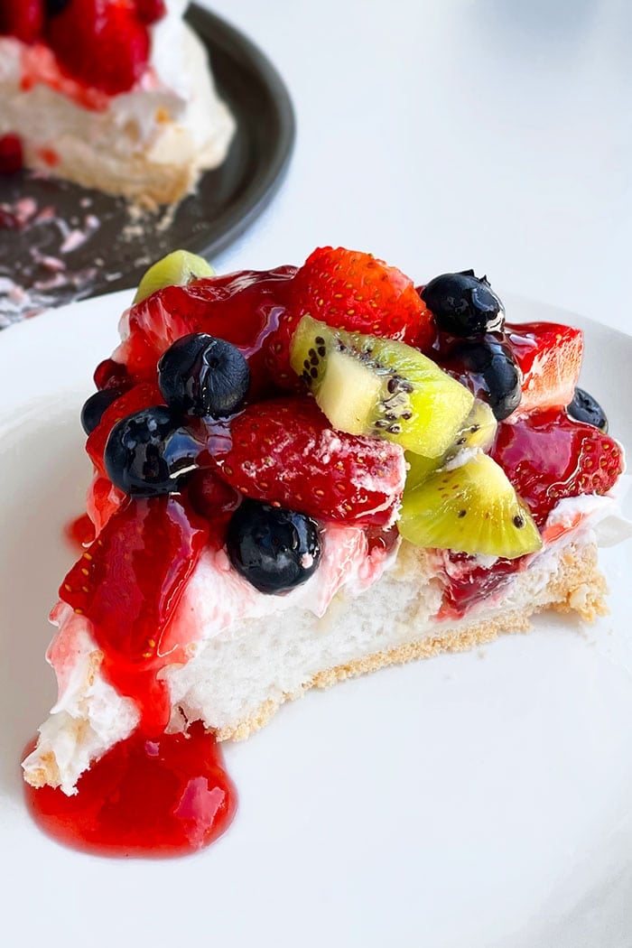 Pavlova Cake Slice in White Plate on White Background 