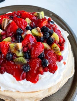 Easy Homemade Pavlova with Whipped Cream and Strawberries Placed on Round Baking Tray