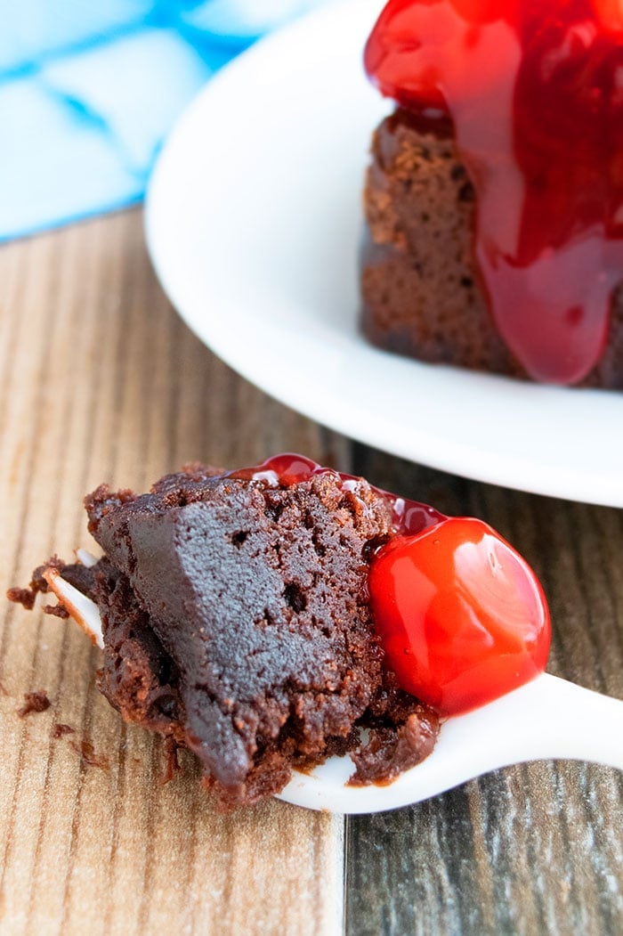 Spoonful of Chocolate Cherry Brownies on Rustic Wood Background