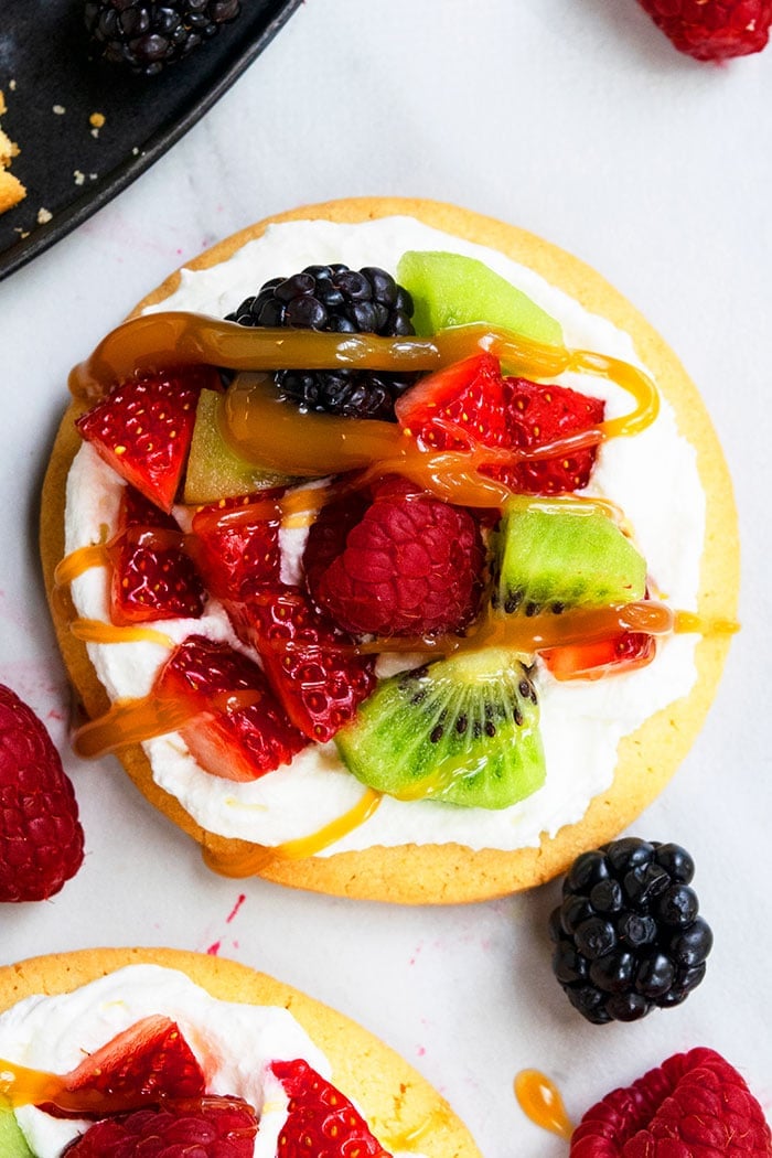 Soft and Chewy Sugar Cookie Pizza on Marble Background- Overhead Shot