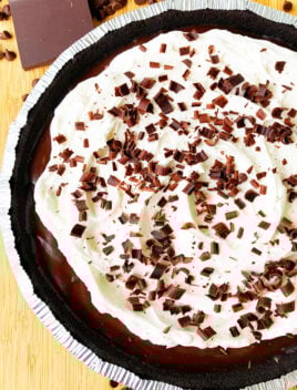 Easy No Bake Chocolate Cream Pie With Oreo Crust on Wood Background