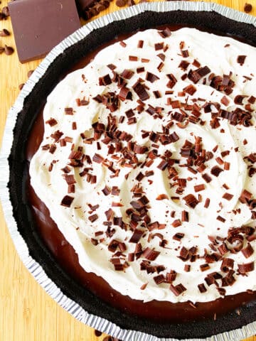 Easy No Bake Chocolate Cream Pie With Oreo Crust on Wood Background