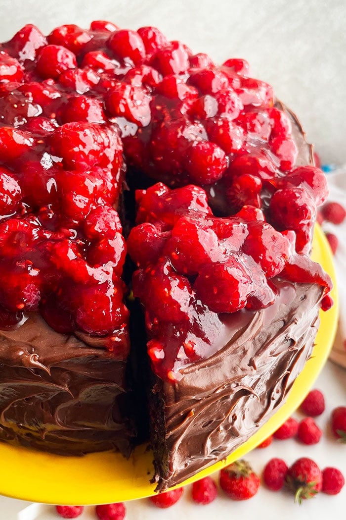 Summer Chocolate Raspberry Cake on Cake Stand With One Slice Cut Out