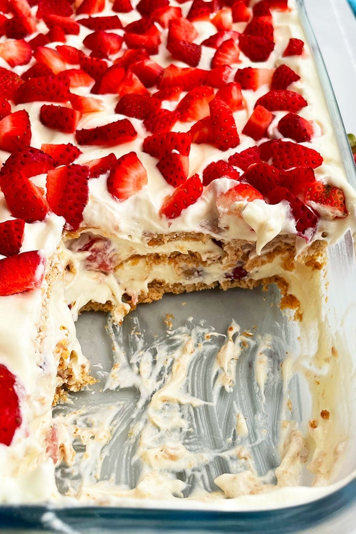 Classic Refrigerated No Bake Graham Cracker Cake With Pudding and Cool Whip and Strawberries- Closeup Shot 