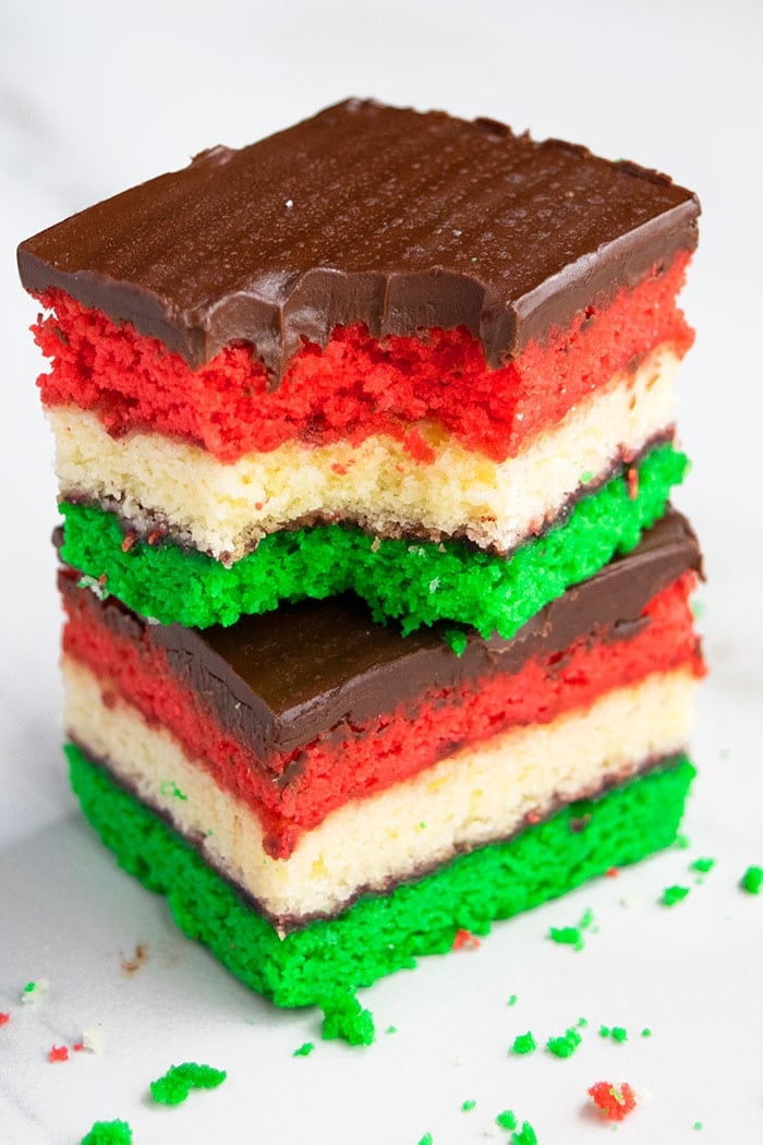 Stack of Two Italian Venetian Cookies or Neapolitan Cookies With a Bite Removed From Top Slice on White Background