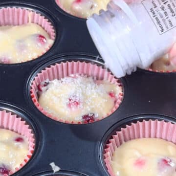 Sparkling sugar being added to top of batter. 