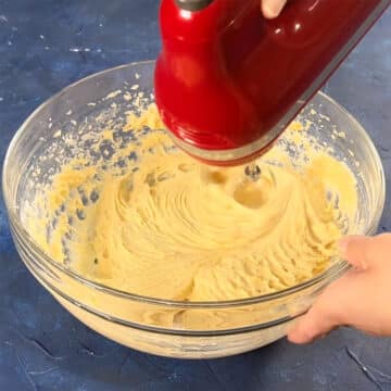 Batter being mixed with a hand held mixer. 