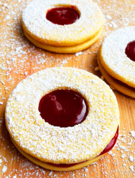 Easy Linzer Cookies Sandwiches With Raspberry Jam on Wood Background