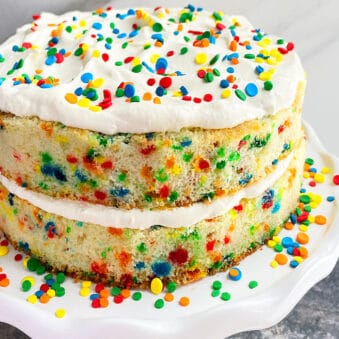 Easy Homemade Funfetti Cake From Scratch on White Cake Stand With Marble Background