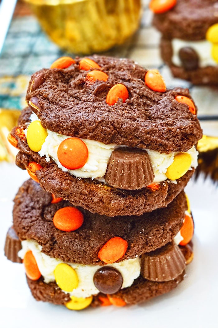 Stack of Reeses Peanut Butter Cookies Sandwiches With Buttercream Icing on White Plate
