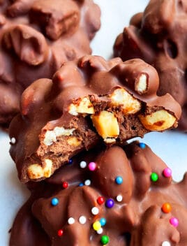 Easy Homemade Crockpot Candy (Chocolate Peanut Clusters) on White Parchment Paper