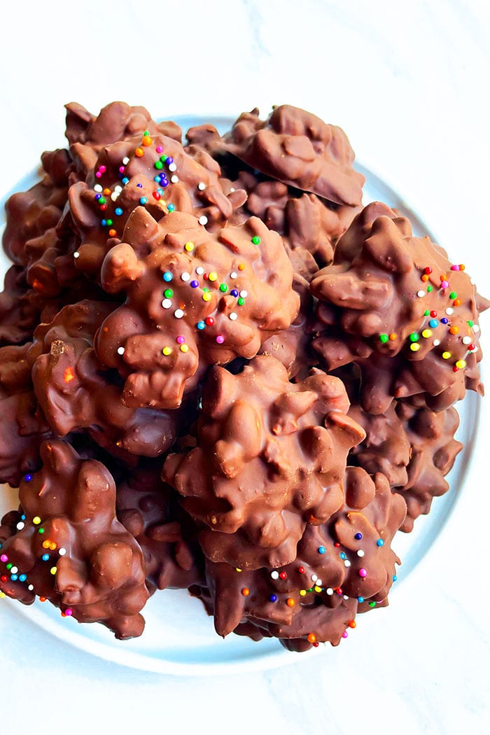 White Plate Full of Chocolate Peanut Clusters- Overhead Shot