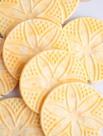 Closeup Shot of Lots of Italian Pizzelle Cookies on White Background